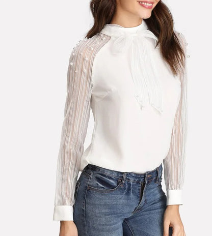Blouse blanche à manches longues avec col lavallière et manches transparentes